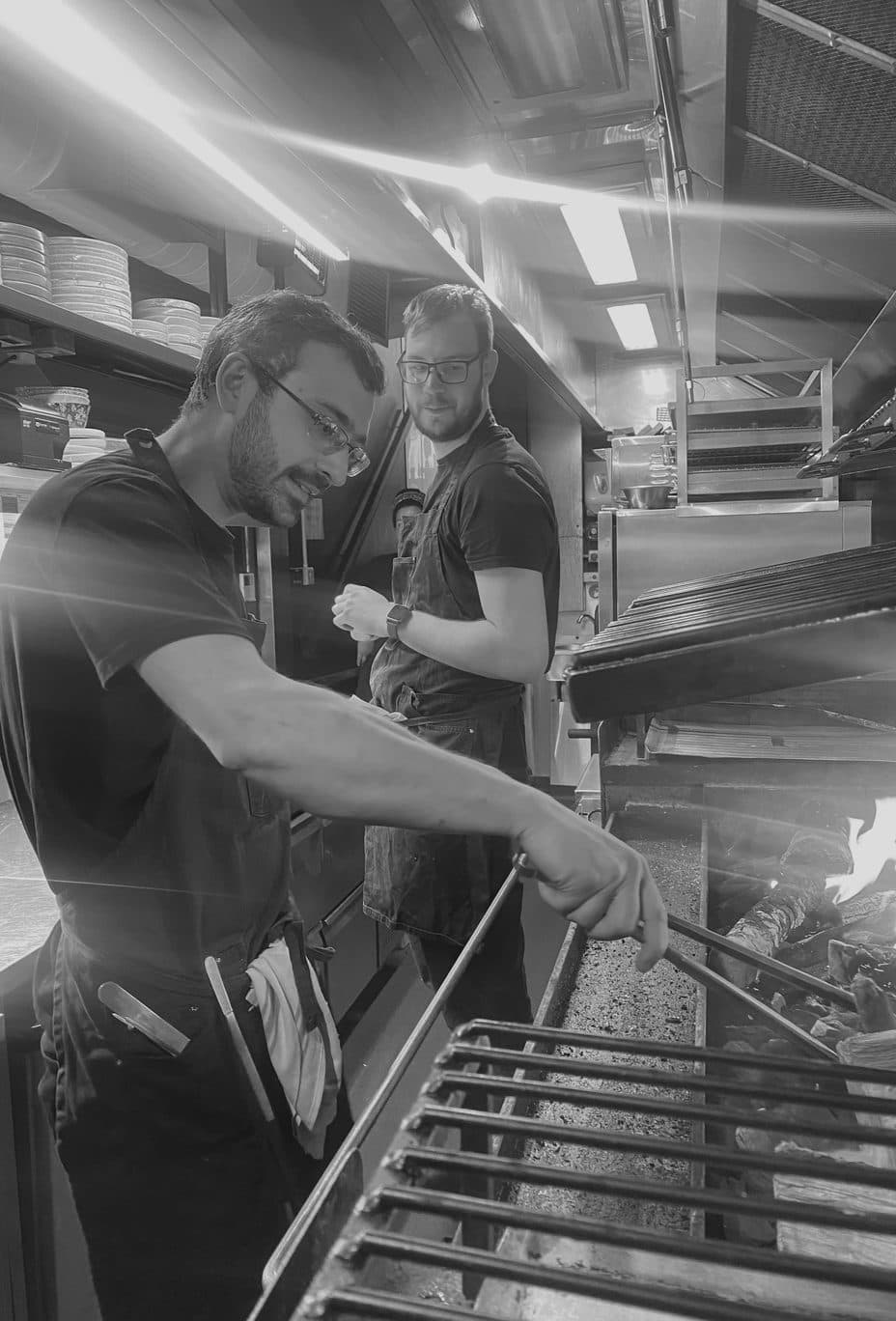 Chefs cooking over the fire in the Hey Annie kitchen
